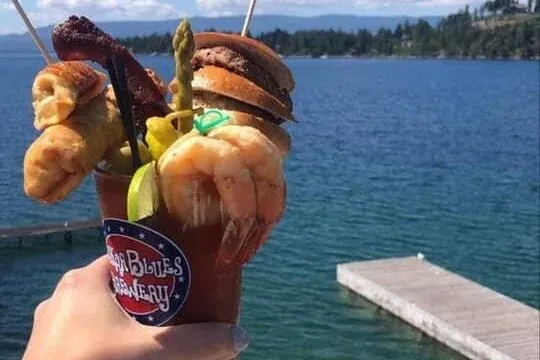 Cocktails and food at The Sitting Duck with Flathead Lake in the background