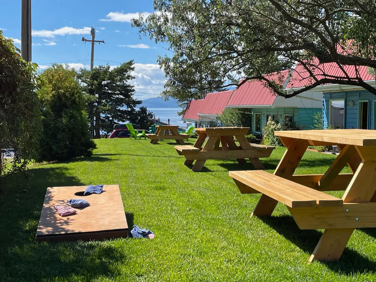 The Islander Inn's lawn with picnic tables and cornhole boards